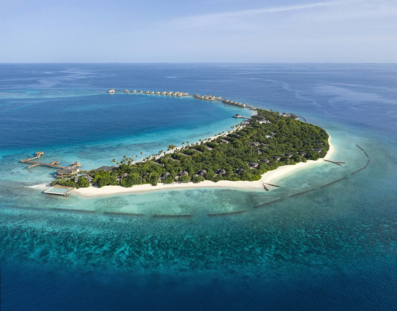 A Maldivian island ringed by its reef, from the air