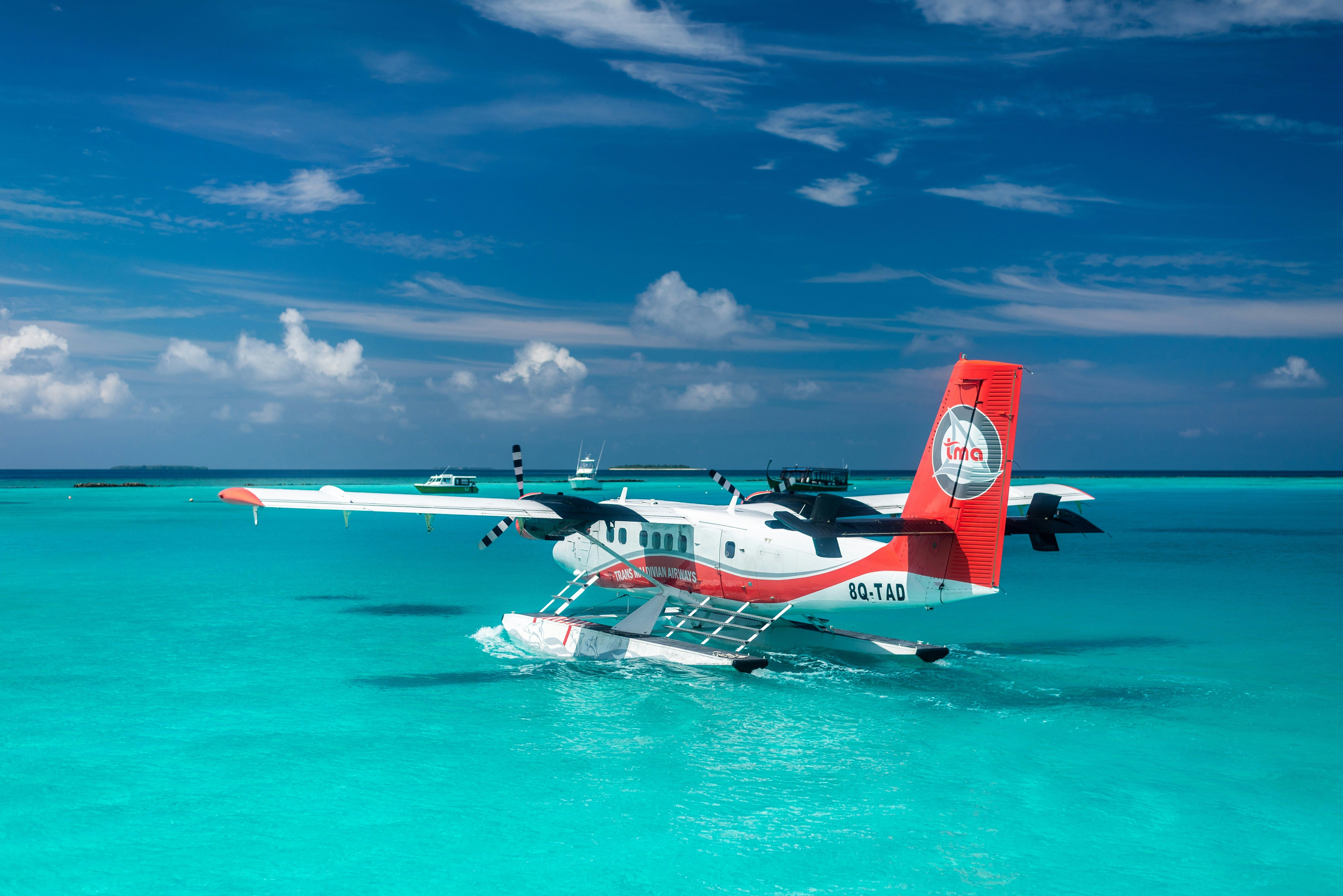 A seaplane on the water beside a jetty
